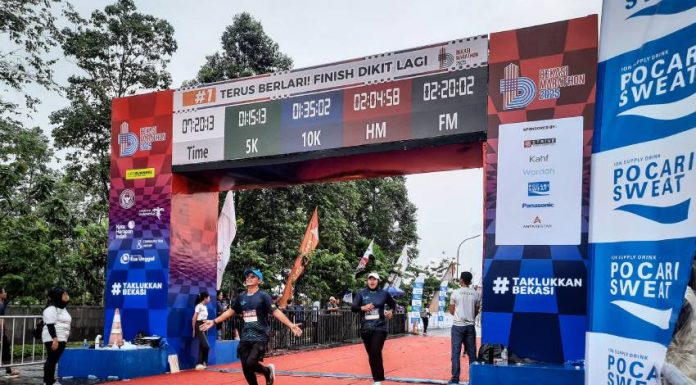 Peserta menunjukan kebahagiannya saat mencapai garis finish pada event Bekasi Marathon Ahad (23/02/2025) di Kota Harapan Indah. Lomba lari ini terbagi dalam beberapa kategori, mulai dari 5K, 10K, hingga half marathon dan full 
marathon. (Foto: RealEstat.id/Adhitya Putra)