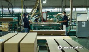 Pekerja di sektor industri furnitur sedang mengoperasikan mesin  untuk membuat pintu lemari. (Foto: RealEstat.id/Adhitya Putra)